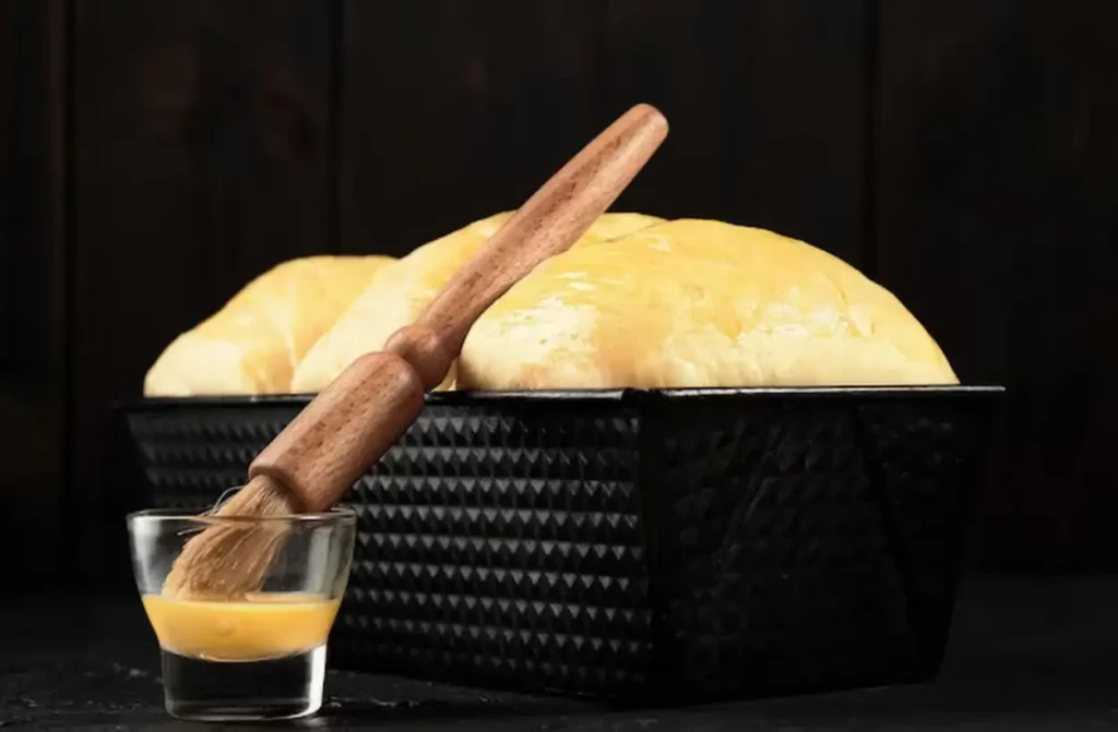 Sweet brioche buns Brioche dough on a tray proofing the dough before baking Baked concept Closeup selective focus