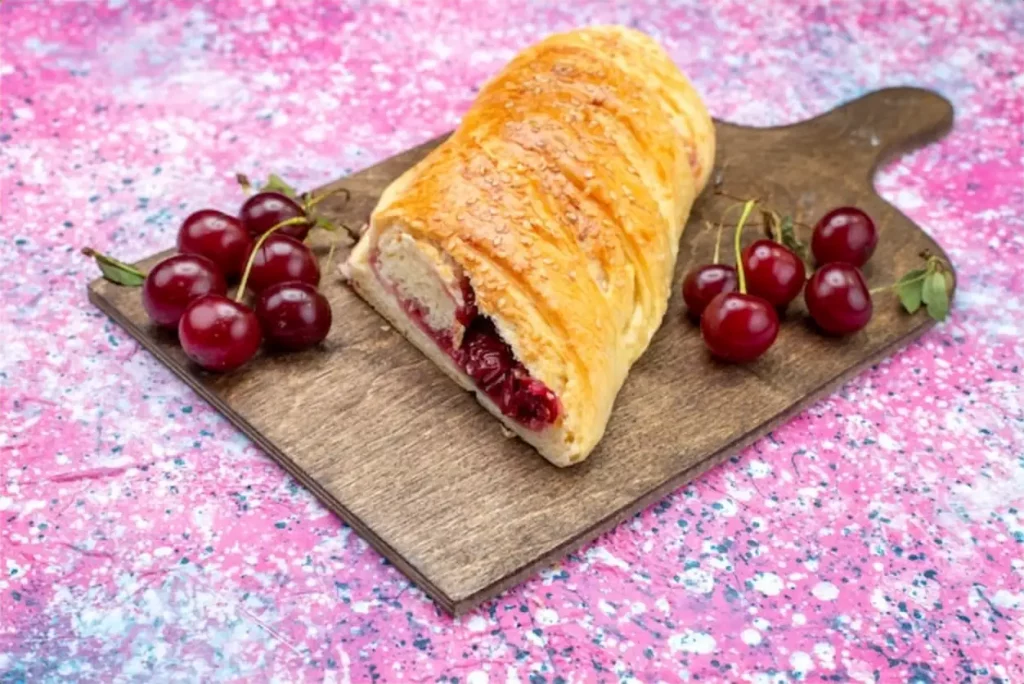 Front view of cherry pastry delicious and sweet sliced with fresh sour cherries