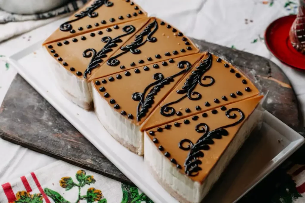 sliced cakes pieces brown designed cream yummy delicious inside white plate on colorful table hot tea