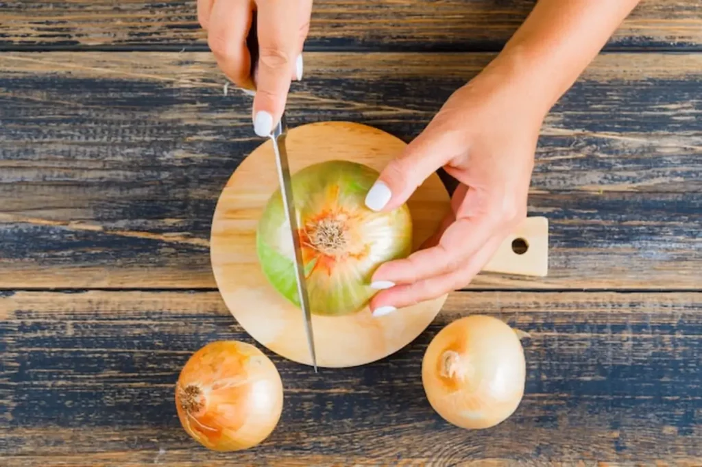 Woman cutting onion using knife